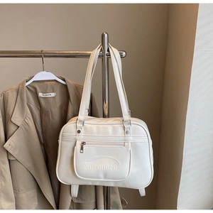 Front view of cream PU leather tote bag with zip pocket and embossed Noronoro logo
