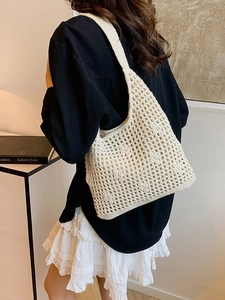 Handmade cream woven tote bag with hollow crochet texture and wide shoulder strap