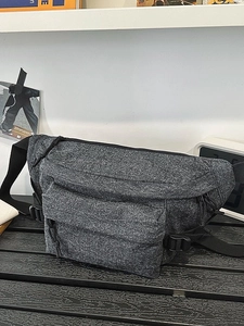 Modern washed denim sling bag in dark grey with multiple functional zipper compartments
