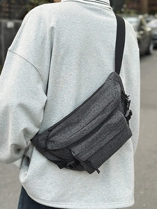Deep grey washed denim crossbody sling bag for men shown worn on back for outdoor cycling