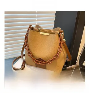 Détails du sac seau caramel texture litchi avec bandoulière chaîne et garniture métal