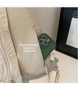 Detail of nylon crossbody bag featuring a large capacity zipper pocket for smartphones