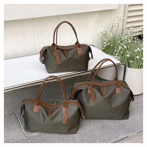 Three-piece olive green tote bag set with brown leather handles on a white garden bench