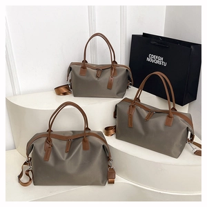 Three khaki nylon tote bags with brown handles on white steps for travel use