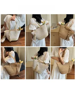 Detail of straw woven beach bag with hollow lace texture and wooden bead tassels