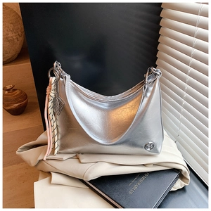 Detail of silver oil wax leather crescent bag with braided strap and metallic logo