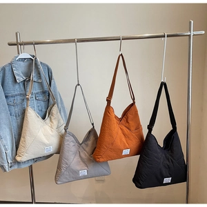 Detailed display of four large-capacity nylon triangle tote bags in various colors