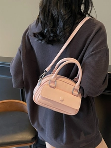 Pink patent leather mini pillow bag with top handles and adjustable shoulder strap