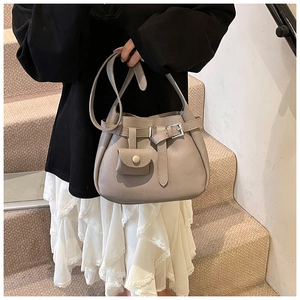 Detail of grey lychee leather bucket bag with silver buckle and matching coin purse