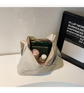 Detail showing the spacious interior of the beige tote bag with daily items