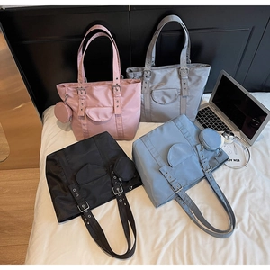 Detailed overhead view of nylon tote bags in four colors with matching coin purses