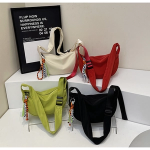 Group display of colorful nylon half-moon crossbody bags in white, red, green and black