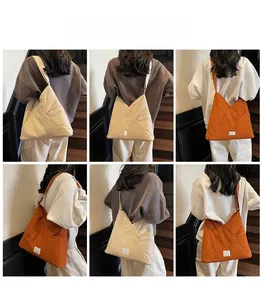 Multiple views of a large capacity crossbody dumpling bag in cream and caramel colors