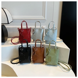 Display of mini tote bags in six colors including red, silver, blue, black, tan, and green
