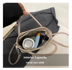Top view of beige bucket bag showing spacious interior with zipper pocket and essentials