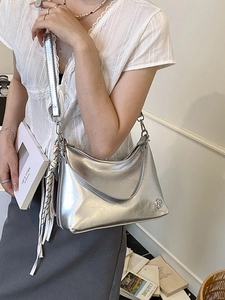 Silver metallic hobo shoulder bag with pleated faux leather texture and wide strap