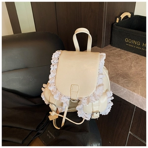 Macro detail of creamy white PU leather backpack featuring vintage ruffled lace trim and strap