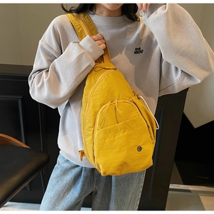 Macro view of bright yellow nylon crossbody chest bag with durable zipper details