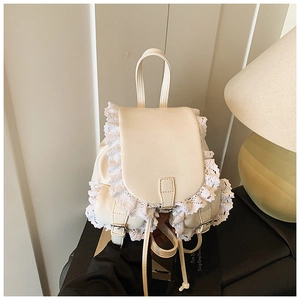 Detail of creamy white PU leather backpack with layered lace trim and silver metal buckle