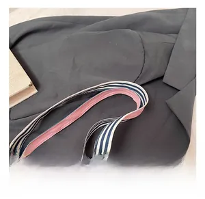 Detailed view of the dual-layer striped handle with navy white and pink fabric stitching