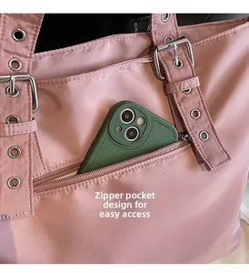 Close-up of pink tote bag showing the front zipper pocket and mobile phone storage