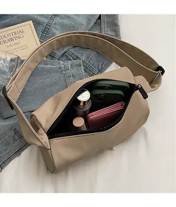 Spacious interior of khaki canvas crossbody bag showing room for phones and wallet