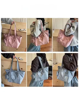 Detail of waterproof nylon tote bags in pink and blue with adjustable shoulder straps