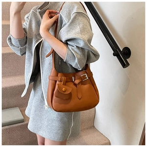 Detailed shot of caramel lychee grain leather crossbody bag with buckle and coin purse