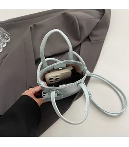 Detailed interior of light blue mini tote bag showing capacity for phone and card holder