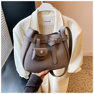 Detail of grey lychee leather bucket bag with adjustable strap and small coin purse