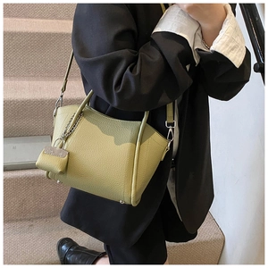 Detailed lime green lychee leather tote bag with chain strap and small purse charm