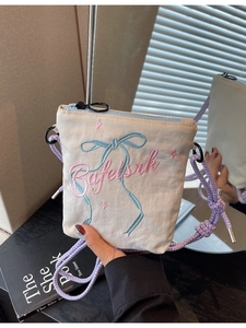 Chic beige canvas bucket bag with blue butterfly embroidery and purple cord strap