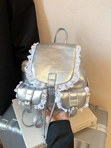 Silver metallic leather backpack with white wave lace trim and buckle pocket design