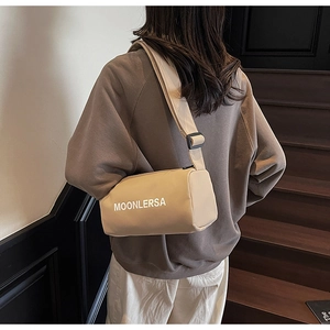 Close-up of the stylish canvas pillow bag with Moonlersa logo and wide shoulder strap