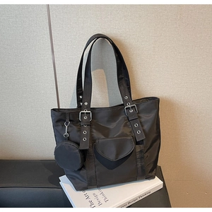 Detail of black nylon tote bag with heart-shaped pocket and detachable coin purse