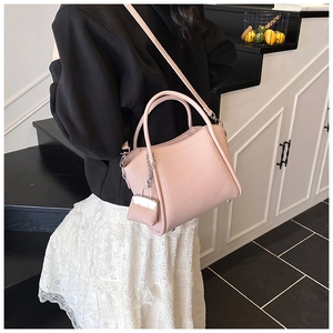 Pink lychee-grain leather bucket bag set with detachable strap and small charm pouch