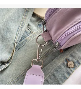 Lavender purple canvas bag detail showing glossy metal hardware and high-density strap