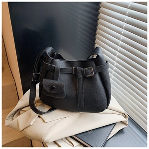 Close-up of black lychee grain leather bucket bag with metallic buckle and mini pouch