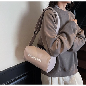 Close-up of light purple canvas barrel bag with MOONLERSA print and wide strap