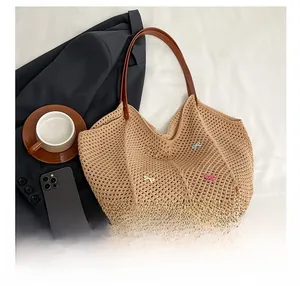 Detail of woven tote bag featuring colorful bows and premium leather shoulder straps