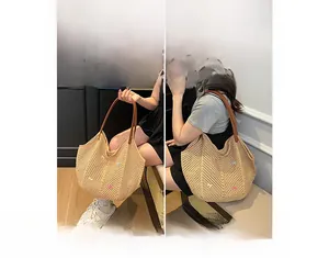 Detail of woven straw tote bag with colorful mini bows and brown leather handles