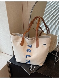 Grand sac cabas en toile beige avec anses en cuir marron et broderie TELN bleue