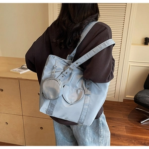 Close-up of light blue nylon tote bag with a matching round coin purse detail