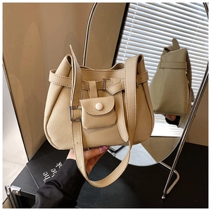 Detail of beige lychee pattern leather bucket bag with detachable coin purse and silver mirror