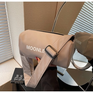 Detail of khaki nylon cylinder crossbody bag with wide strap and Moonle logo