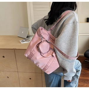 Pink nylon tote bag with matching round coin purse showing large capacity detail