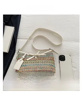 Detail shot of the colorful woven texture with a cream leather strap and fashion tag