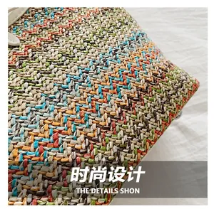 Macro detail of multi-colored woven texture on shoulder bag with white leather trim