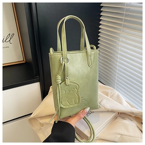 Mini light green PU leather bucket bag featuring a cute bear charm and silver hardware