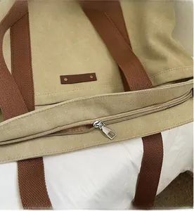 Detail view of smooth silver metal zipper closure on large canvas tote bag
